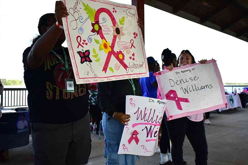Well-wishers of those fighting breast cancer and those honoring the memory of breast cancer patients recognize their loved ones with posters. (Pine Bluff Commercial/I.C. Murrell)