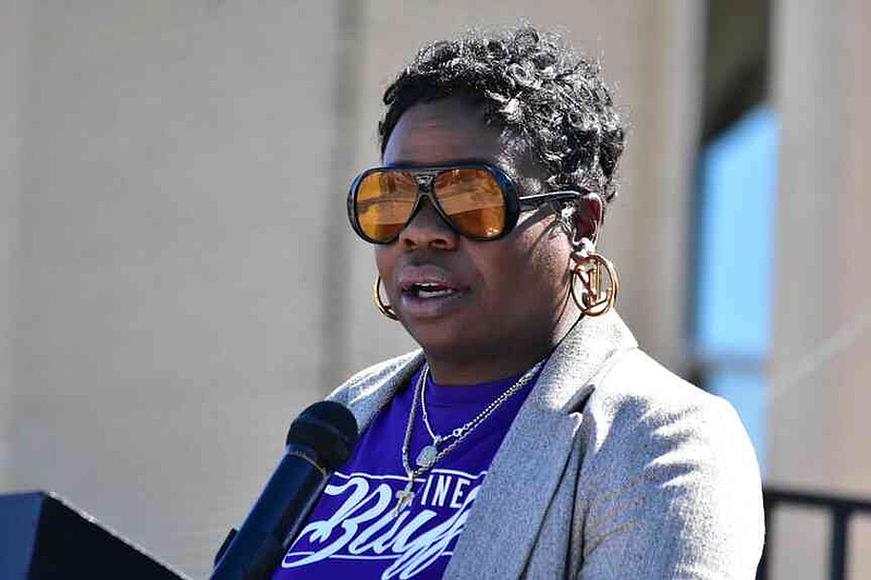 Pine Bluff Ward 1 Councilwoman Latisha Brunson talks with visitors about going forward in the years since her mother's 1999 death due to domestic violence. (Pine Bluff Commercial/I.C. Murrell)