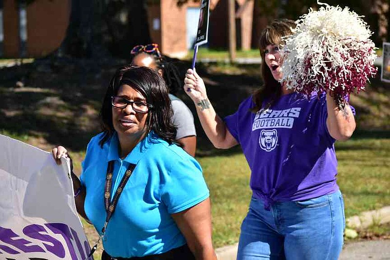 Pine Bluff Police Officer Nadine Marshall leads a chant as supporters march with her against domestic violence. (Pine Bluff Commercial/I.C. Murrell)