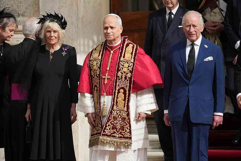 Pope Leo XIV, center, poses flanked by Britain's King Charles III and Queen Camilla in the St. Damasus Courtyard at the Vatican after a state visit and pray with him in the Sistine Chapel, Thursday, Oct. 23, 2025. (AP Photo/Andrew Medichini)