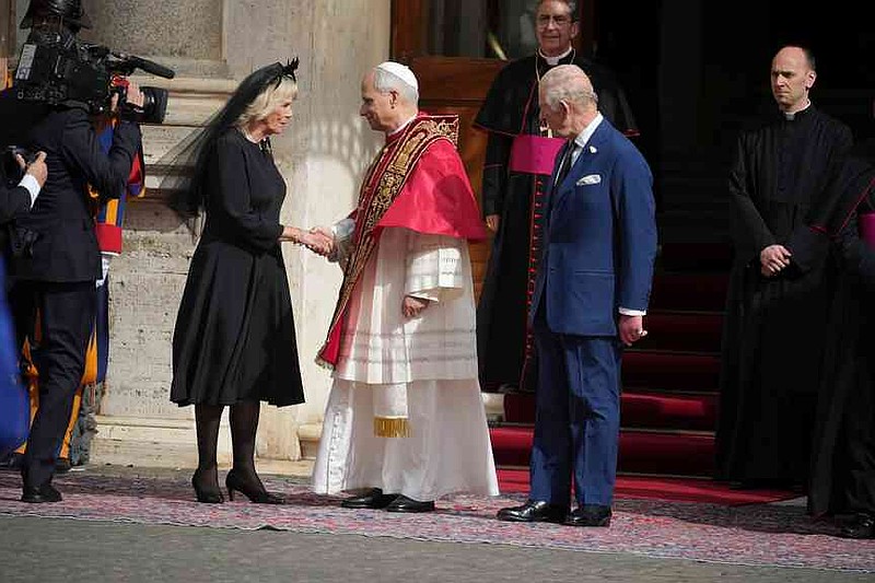 Pope Leo XIV, center, cheers with Queen Camilla and Britain's King Charles III in the St. Damasus Courtyard at the Vatican after a state visit and pray with him in the Sistine Chapel, Thursday, Oct. 23, 2025. (AP Photo/Andrew Medichini)