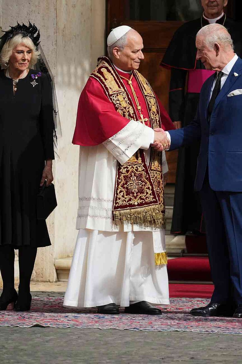 Pope Leo XIV, center, cheers with Britain's King Charles III and Queen Camilla in the St. Damasus Courtyard at the Vatican after a state visit and pray with him in the Sistine Chapel, Thursday, Oct. 23, 2025. (AP Photo/Andrew Medichini)