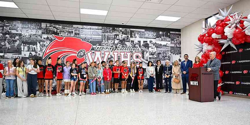 Tim Sparacino (right), Washington Junior High School principal, speaks Tuesday during a ceremony announcing the school becoming the sixth parent-choice school in the Bentonville School District at the school in Bentonville. Each Bentonville parent-choice school has themed programming, such as arts or leadership development, that is integrated into the curriculum. Visit nwaonline.com/photo for today's photo gallery. (NWA Democrat-Gazette/Caleb Grieger)