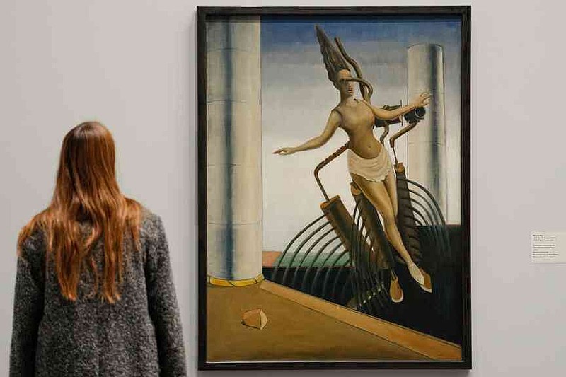 A woman looks at the artwork