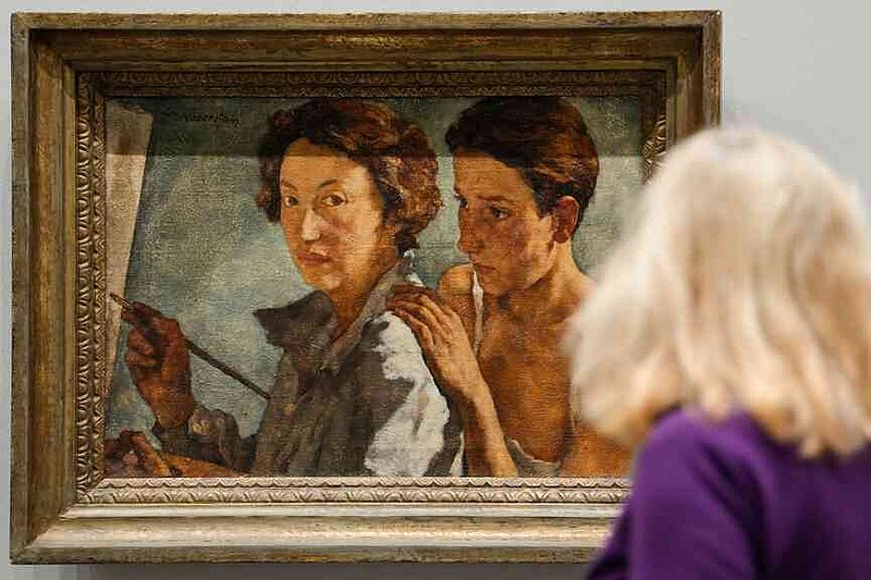 A woman looks at the artwork