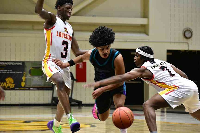 Cadell Wallace of Southeast Arkansas College splits the double team of Dominick Baptiste (3) and Jay Reddix (2) of Louisiana's Community Christian College in the first half Tuesday at H.O. Clemmons Arena. (Pine Bluff Commercial/I.C. Murrell)