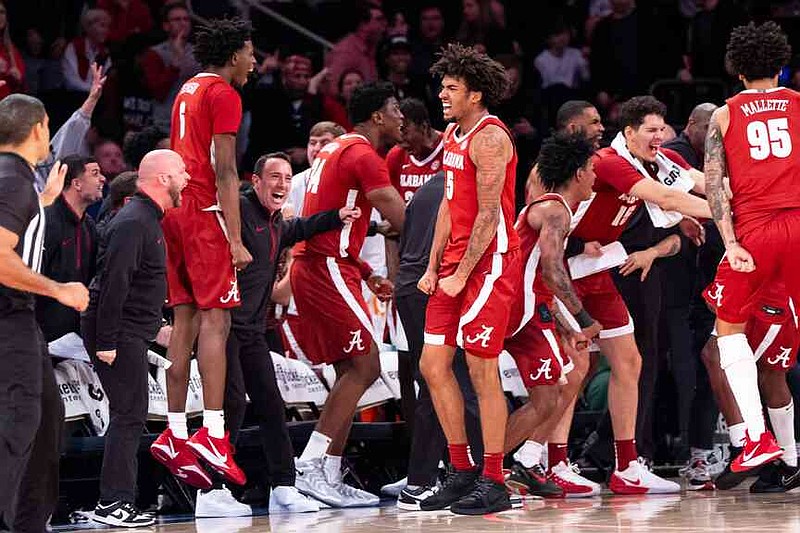 Alabama forward Amari Allen (5) and teammates celebrate a basket near the end of the second half of an NCAA college basketball game against St. John’s, Saturday, Nov. 8, 2025, in New York. (AP Photo/Angelina Katsanis)