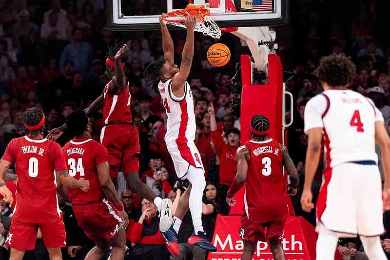 St. John’s forward Zuby Ejiofor (24) dunks during the first half of an NCAA college basketball game against Alabama, Saturday, Nov. 8, 2025, in New York. (AP Photo/Angelina Katsanis)
