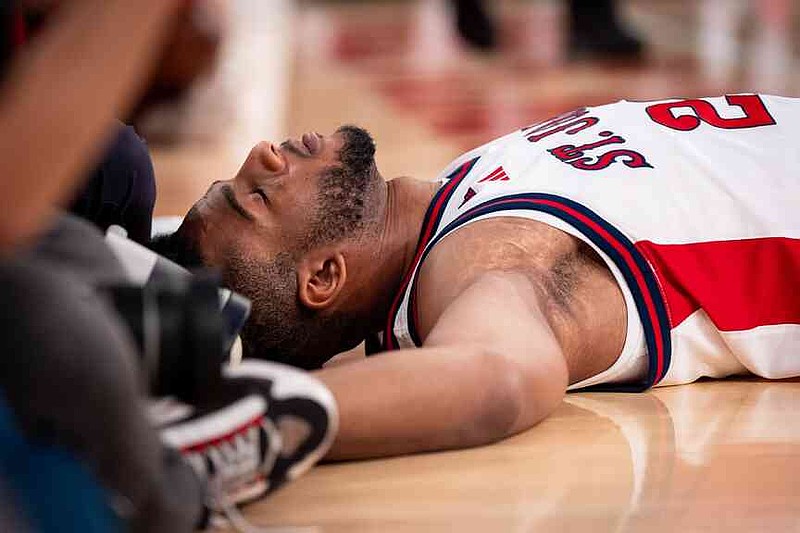 St. John’s forward Zuby Ejiofor (24) lays on the court after a fall during the second half of an NCAA college basketball game against Alabama, Saturday, Nov. 8, 2025, in New York. (AP Photo/Angelina Katsanis)