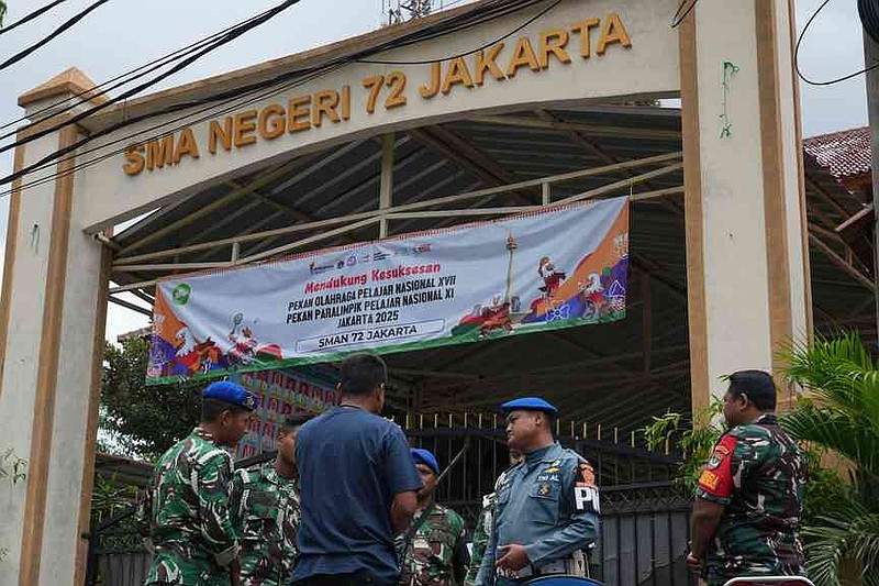Military personnel stand guard at the gate of a school after explosions in Jakarta, Indonesia, Saturday, Nov. 8, 2025. (AP Photo/Achmad Ibrahim)
