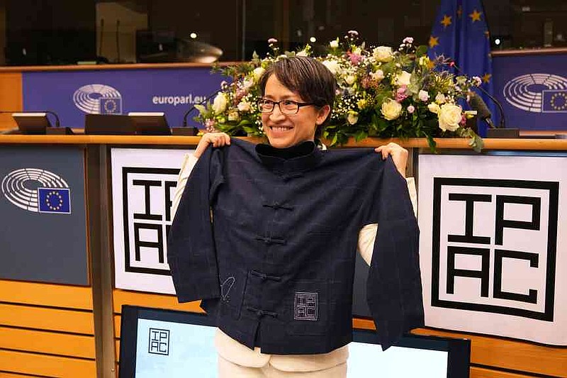 Taiwan’s Vice President Bi-Khim Hsiao poses with a gift she received at the European Parliament in Brussels, Friday, Nov. 7, 2025. (AP Photo/Virginia Mayo)