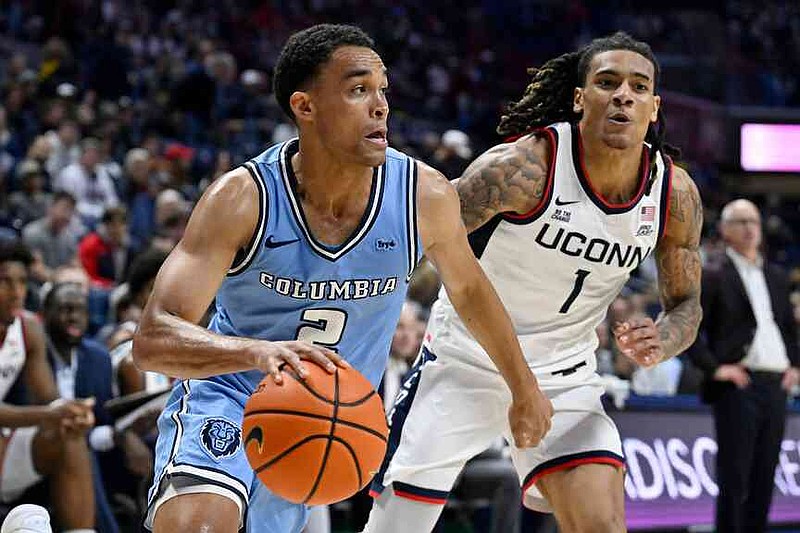Columbia guard Kenny Noland (2) is guarded by UConn guard Solo Ball (1) in the first half of an NCAA college basketball game, Monday, Nov. 10, 2025, in Storrs, Conn. (AP Photo/Jessica Hill)