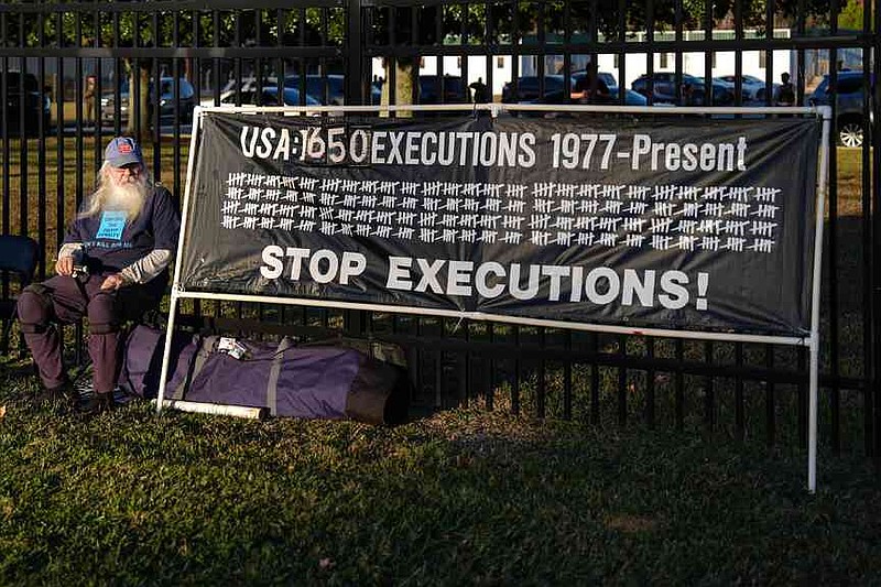 A protester looks on outside of Broad River Correctional Institute ...