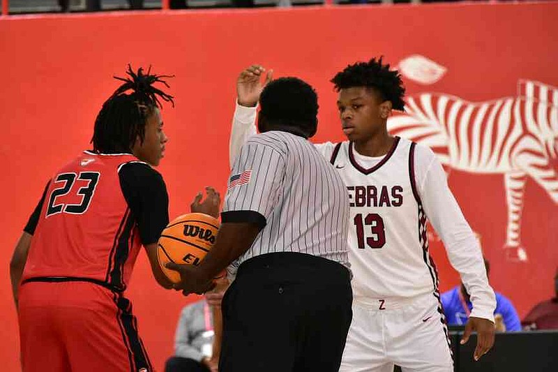 Elijah Span (23) of Jacksonville and Trevion Thorns (13) of Pine Bluff set up for the opening tipoff Friday, Nov. 14, 2025, at the Jack Robey campus. (Pine Bluff Commercial/I.C. Murrell)