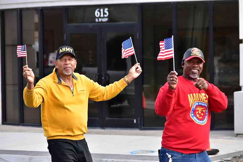 Two men walk past 615 S. Main St. during the Pine Bluff Regional Veterans Parade on Saturday, Nov. 15, 2025. (Pine Bluff Commercial/I.C. Murrell)