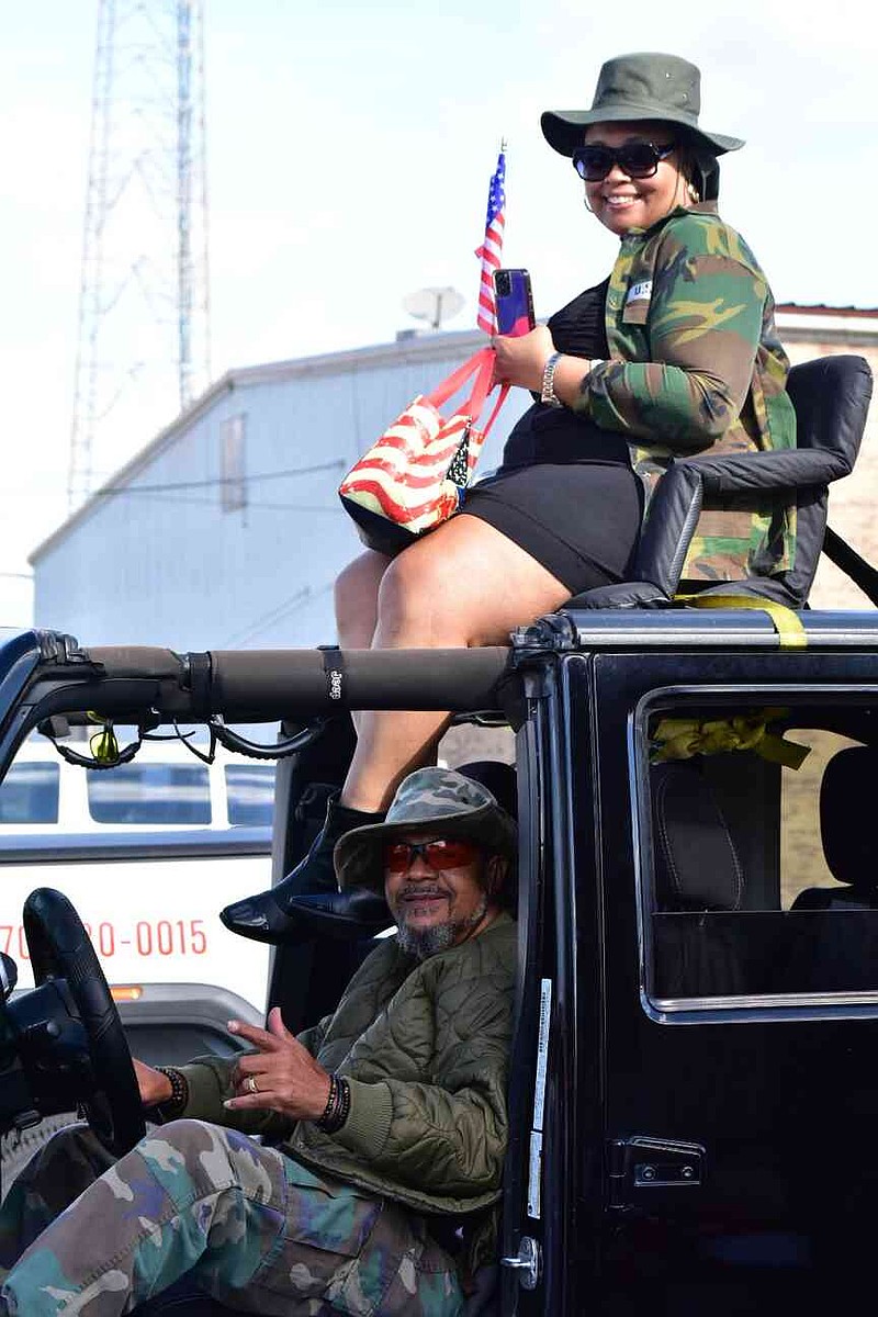 Melanie Madkin rides atop a vehicle driven by Melvin Wilkes in the Pine Bluff Regional Veterans Parade on Saturday, Nov. 15, 2025. (Pine Bluff Commercial/I.C. Murrell)