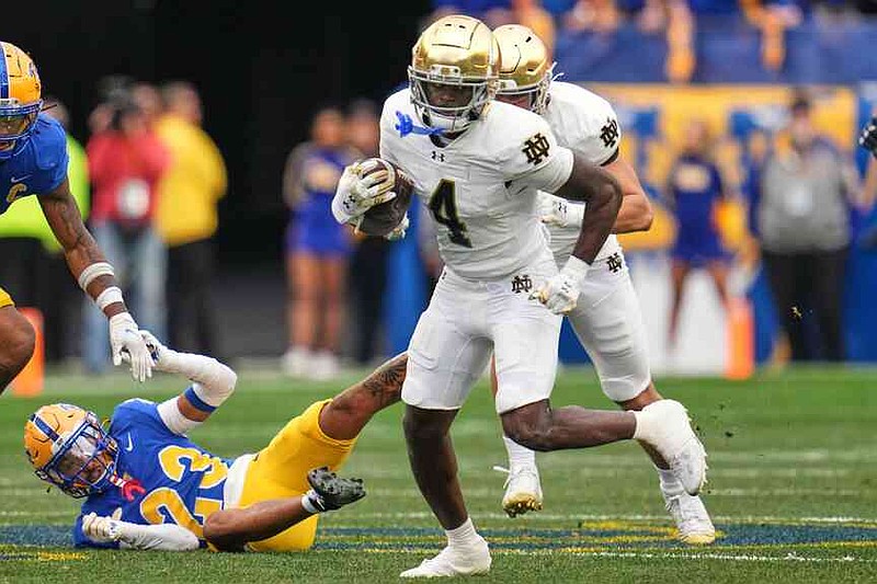 Notre Dame running back Jeremiyah Love (4) gets past Pittsburgh defensive back Kavir Bains (23) en route to a 65-yard touchdown run during the first half of an NCAA college football game in Pittsburgh, Saturday, Nov. 15, 2025. (AP Photo/Gene J. Puskar)