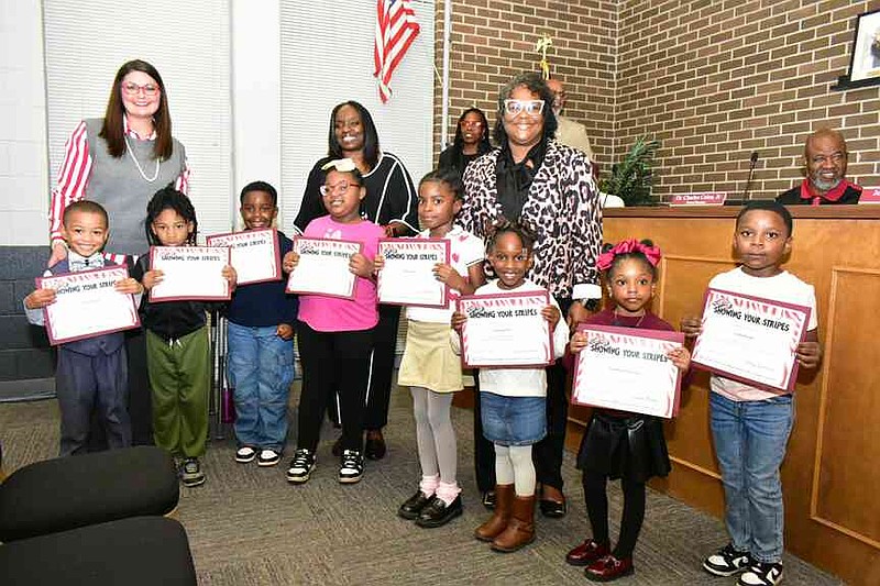 Young students are honored for recent performance on the ATLAS summative battery and following their social contracts during a Pine Bluff School District board meeting Monday, Nov. 17, 2025. (Pine Bluff Commercial/I.C. Murrell)