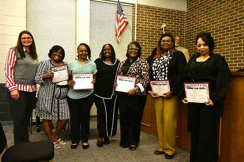 Pine Bluff School District faculty members receive Showing Your Stripes awards from Superintendent Jennifer Barbaree (far left). Also pictured from left: Pauline Criss, Marcia Wilkins, Forrest Park/Greenville Principal Marceinia Peoples; assistant principal Sheritta Sanders; April Williams and Pasha Jackson. (Pine Bluff Commercial/I.C. Murrell)