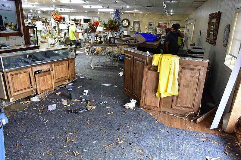 A jewelry display stand and welcome stand are visibly damaged inside Sissy's Log Cabin on South Camden Road on Thursday, Nov. 20, 2025. (Pine Bluff Commercial/I.C. Murrell)
