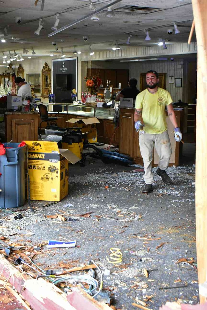 A man from a contracting crew helps with cleanup inside Sissy's Log Cabin on South Camden Road on Thursday, Nov. 20, 2025, hours after a Pine Bluff police officer in a cruiser drove into the jewelry store. (Pine Bluff Commercial/I.C. Murrell)