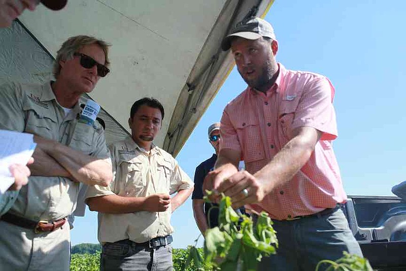 Associate Professor Ben Thrash, right, with the University of Arkansas System Division of Agriculture conducts a session in August 2019 at the Crop Research Field Day at the Lon Mann Research Station in Marianna. Agronomists and researchers of the Division of Agriculture discussed the latest research and findings in Arkansas row crops. (Special to The Commercial/Ryan McGeeney/University of Arkansas System Division of Agriculture)