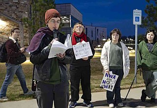 Emory Hopkins, senior campaign organizer with Sierra Club, speaks Thursday during a rally outside the Washington County campus of Northwest Arkansas Community College in Springdale. Southwestern Electric Power Co. submitted a request with the Arkansas Public Service Commission in March to raise residential electric rates by 27.3%, though that request has now been dropped to 24%. Visit nwaonline.com/photo for today's photo gallery. (NWA Democrat-Gazette/Charlie Kaijo)
