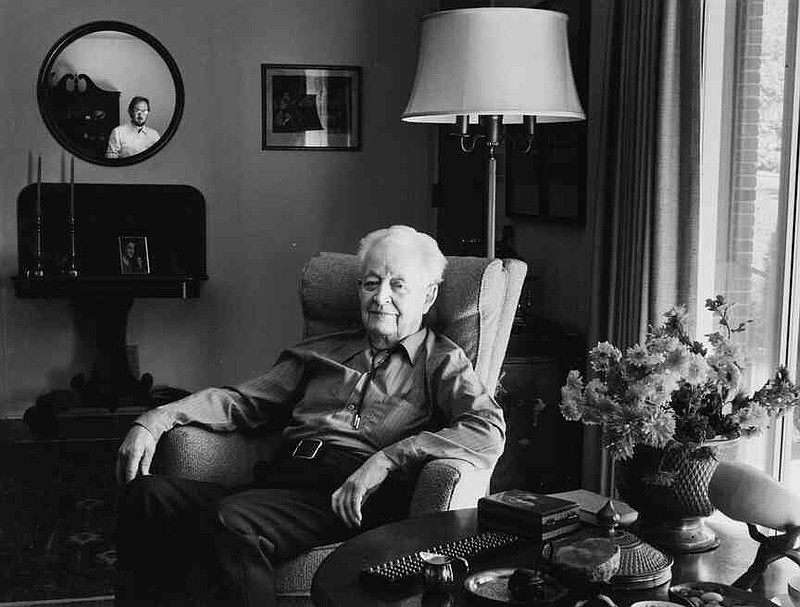 Andrew Kilgore (in mirror reflection) photographs William Bryson, retired rear admiral of the U.S. Navy and retired associate professor emeritus of engineering science at the University of Arkansas November of 1980. The image is part Andrew Kilgore's ‚