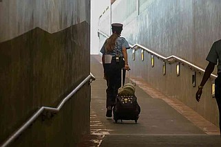 FILE - An Amtrak worker walks up the train ramp at Union Station in Los Angeles, July 19, 2024.