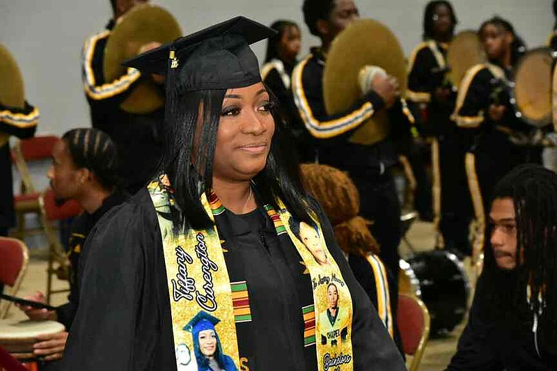 Tiffany Curengton of Pine Bluff marches into the Pine Bluff Convention Center arena to receive her degree in criminal justice at the University of Arkansas at Pine Bluff fall commencement Saturday, Dec. 13, 2025. (Pine Bluff Commercial/I.C. Murrell)