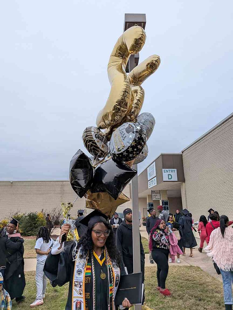 Jerrica Higgins of Pine Bluff celebrates graduation with balloons following University of Arkansas at Pine Bluff fall commencement Saturday, Dec. 13, 2025. (Pine Bluff Commercial/I.C. Murrell)