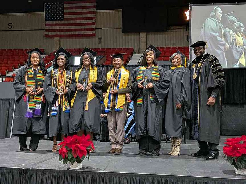 Winners of the Chancellor's Medallions at the University of Arkansas at Pine Bluff are honored during the fall commencement Saturday, Dec. 13, 2025: From left, winners Messhirya Harris of Marianna; Ashley Robinson of West Palm Beach, Fla., Cornelia Watts of Houston, Kaiel Kimble of Houston, and Kyla M. Boatner of Dermott; registrar Aretha Lacefield and Chancellor Anthony Graham. (Pine Bluff Commercial/I.C. Murrell)