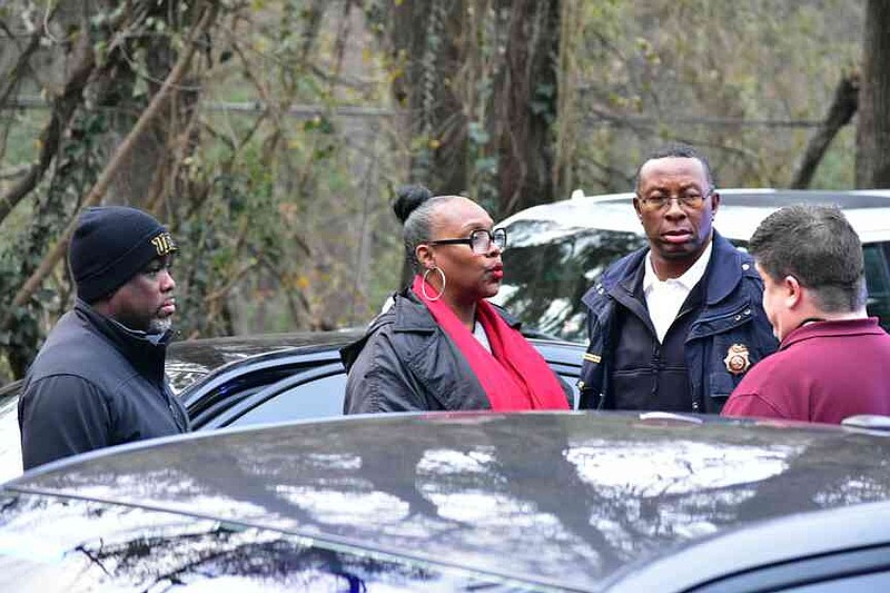 From left, 11th West Circuit Judge Alex Guynn, Pine Bluff Mayor Vivian Flowers, Pine Bluff Interim Fire Chief Randy Compton and police public information specialist John Worthen converse following a standoff at the home of former police personality Will Jenkins on Wednesday, Dec. 17, 2025. (Pine Bluff Commercial/I.C. Murrell)