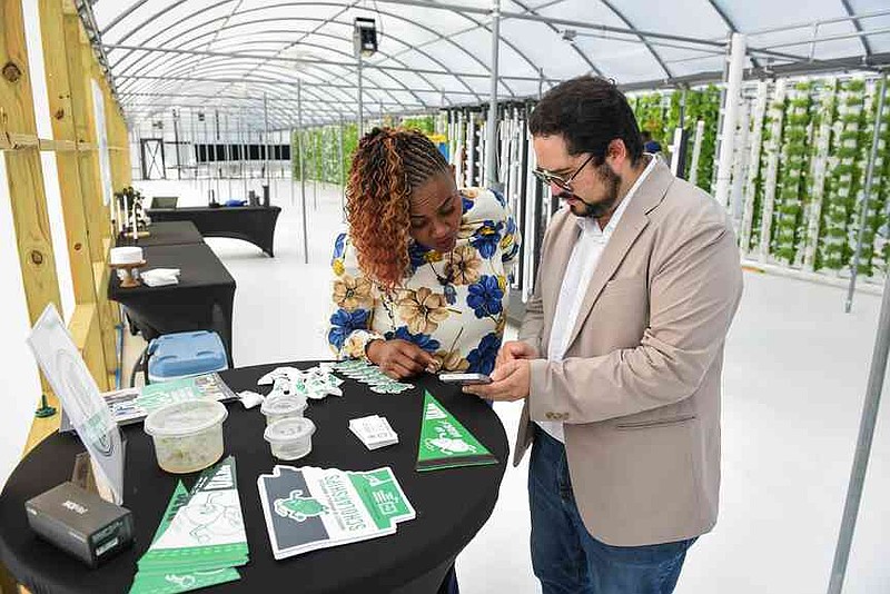 Arturo Quintero Ferrer (right) shared his research project at the Harvest the Futur' open house at 180 Pipe, the vertical pipe farm in Sheridan on Oct. 14. (Special to The Commercial/Luigi Campos)