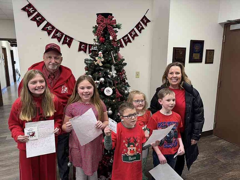 Hardin Elementary School What Christmas Means to Me winners pose with organizers. From left: Khloe Stewart, fifth grade; Abigail Meyer, fourth grade; Beau Reagan, kindergarten; Greyson Paden, first grade; and far left rear: Joe Spadoni; Presley Nooner, second grade; and far right rear: Debbie Johnson. (Special to The Commercial)