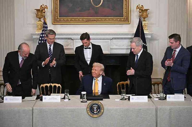 FILE - President Donald Trump, center, sits as Secretary of Commerce Howard Lutnick, from left, Treasury Secretary Scott Bessent, and from right, Bo Hines, a member of the presidential council of advisers for digital assets, and White House AI and crypto czar David Sacks attend the White House Crypto Summit in Washington, March 7, 2025. (Pool via AP, File)