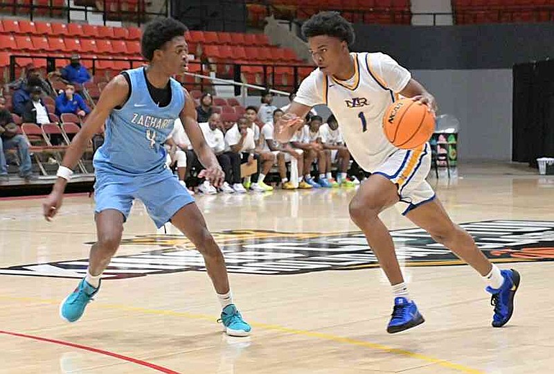 Deezy Collins of Zachary, La., defends against Kevon Smith of North Little Rock in the first half of a King Cotton Holiday Classic game Saturday, Nov. 27, 2025, at the Pine Bluff Convention Center. (Pine Bluff Commercial/I.C. Murrell)
