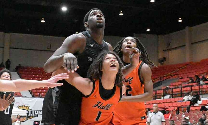 Marcis Ponder of Gillion Academy (Springfield, Va.) towers above Tristian Jahnke (1) and Landen Hill (12) of Little Rock Hall in the second half of a King Cotton Holiday Classic on Saturday, Dec. 27, 2025, at the Pine Bluff Convention Center. (Pine Bluff Commercial/I.C. Murrell)