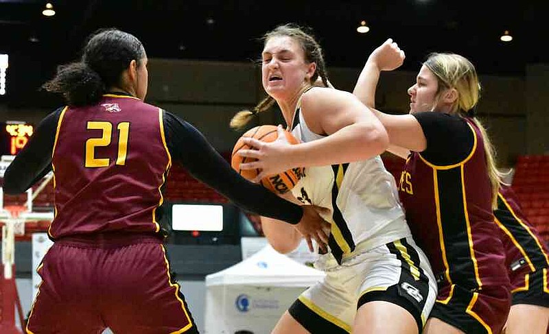 Caroline Bradley of Oak Grove, La., is double teamed by Disyah Christon (21) and Gracen Hurley (11) of Lake Hamilton in the first half of a King Cotton Holiday Classic game Monday, Dec. 29, 2025, at the Pine Bluff Convention Center. (Pine Bluff Commercial/I.C. Murrell)