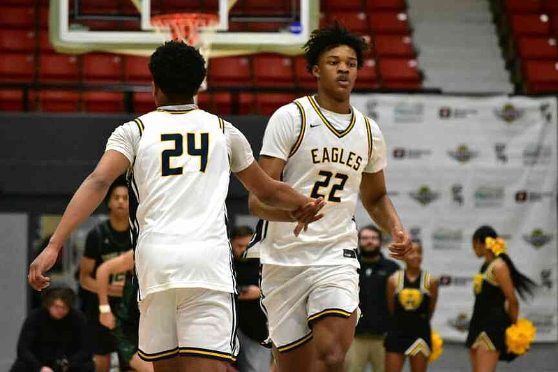 Josiah Rose (24) congratulates Xavier Young (22) after a made basket against Inglewood, Calif., in the first quarter of the King Cotton Holiday Classic championship game Tuesday, Dec. 30, 2025, at the Pine Bluff Convention Center. (Pine Bluff Commercial/I.C. Murrell)