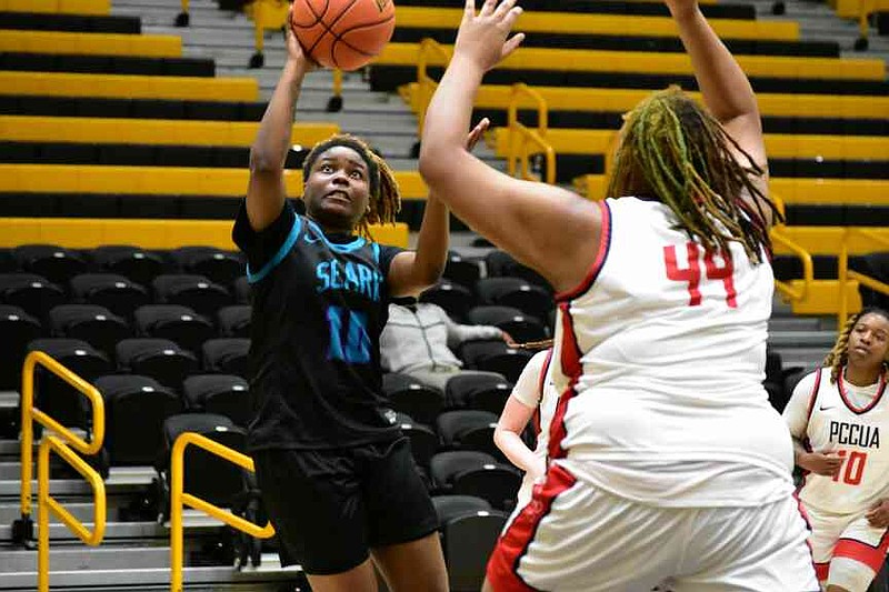 Stephana Steen of Southeast Arkansas College goes past Toni Henderson of Phillips Community College of the University of Arkansas for a shot in the second half Wednesday, Jan. 7, 2026, at H.O. Clemmons Arena. Steen is from Dumas. (Pine Bluff Commercial/I.C. Murrell)