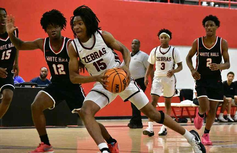 Quentin Adams of Pine Bluff drives to the basket against Bobby Foster of White Hall in the first quarter Friday, Jan. 9, 2026, at Pine Bluff's Jack Robey campus. (Pine Bluff Commercial/I.C. Murrell)