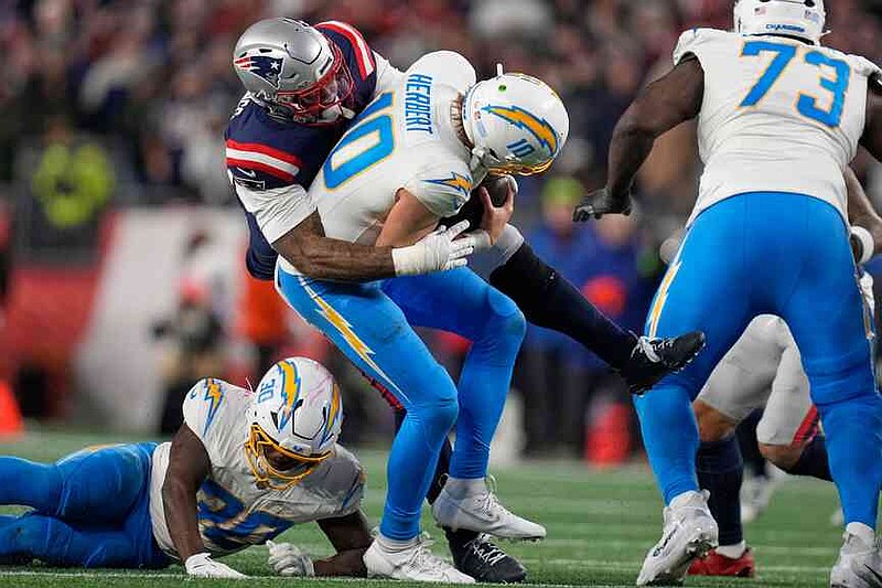 New England Patriots linebacker Anfernee Jennings sacks Los Angeles Chargers quarterback Justin Herbert (10) in the second half of an NFL wild-card playoff football game in Foxborough, Mass., Sunday, Jan. 11, 2026. (AP Photo/Charles Krupa)