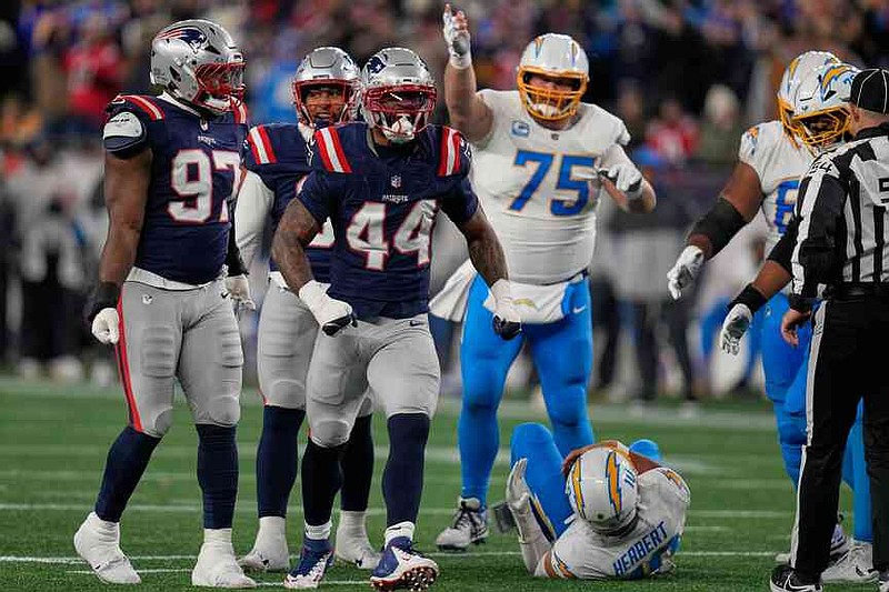New England Patriots linebacker K'lavon Chaisson (44) celebrates a sack of Los Angeles Chargers quarterback Justin Herbert (10) in the first half of an NFL wild-card playoff football game in Foxborough, Mass., Sunday, Jan. 11, 2026. (AP Photo/Charles Krupa)