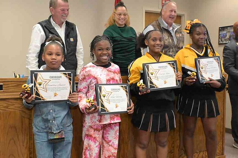 Winners of campus Spelling Bees in the Watson Chapel School District are honored during a district board meeting Monday, Jan. 12, 2026, with board members in the background: front from left, Brentley James and Kali Horton of Coleman Elementary and Caelyn Rose and Lakyah Buckner of Watson Chapel Junior High; back row from left, Donnie Hartsfield, Rosemary White and Alan Frazier. (Pine Bluff Commercial/I.C. Murrell)