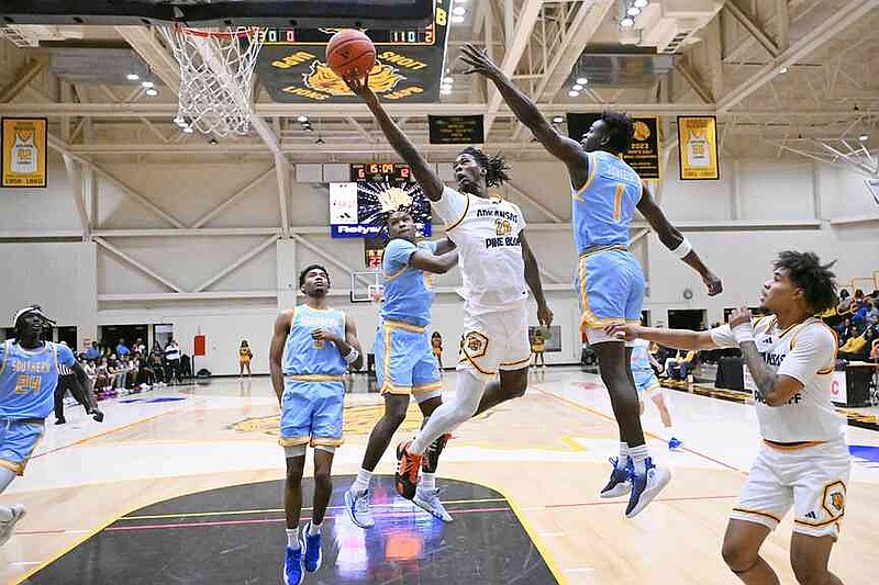 UAPB junior guard Doctor Bradley attempts a layup while defended by Southern senior DeMariee Jones (1) and junior AJ Barnes (12) during a Jan. 25, 2025, men's basketball game at H.O. Clemmons Arena in Pine Bluff. (Special to the Commercial/William Harvey)