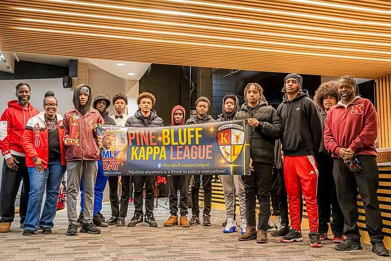 Monica Bones, president of the Pine Bluff Alumnae Chapter of Delta Sigma Theta Sorority Inc., presents the first-place trophy for the banner contest to the Kappa League. (Pine Bluff Commercial/Eplunus Colvin)