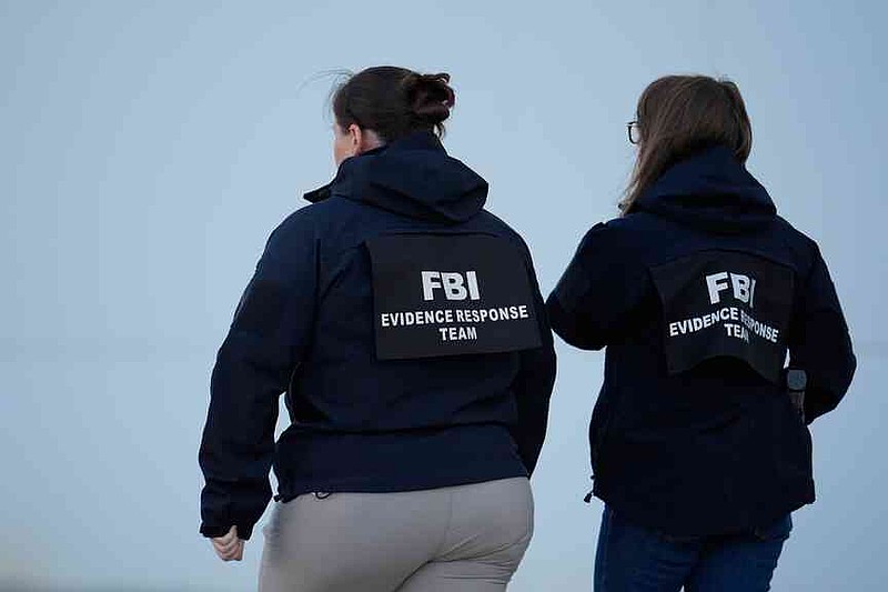 FBI officers are seen at the Fulton County Election Hub and Operation Center, Wednesday, Jan. 28, 2026, in Union City, Ga, near Atlanta. (AP Photo/Mike Stewart)