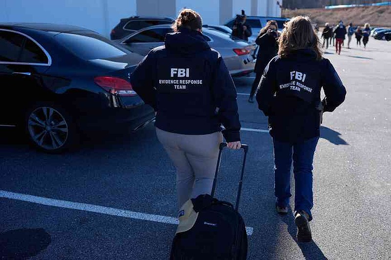 FBI officers are seen at the Fulton County Election Hub and Operation Center, Wednesday, Jan. 28, 2026, in Union City, Ga, near Atlanta. (AP Photo/Mike Stewart)