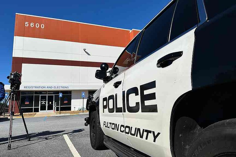 Police vehicles are seen outside the Fulton County elections hub in Union City, Ga., Wednesday, Jan. 28, 2026. (AP Photo/Emilie Megnien)